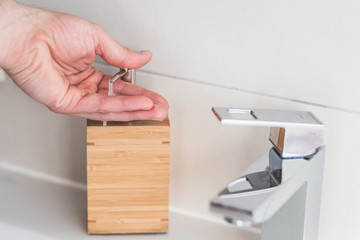 Obraz premium Hand washing with soap in bathroom to prevent contamination, close up