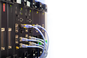 Network hardware. Optical fiber. White cables are connected to network equipment. Server close up. A fragment of server hardware. Place for text near the server. Providing Internet in the company