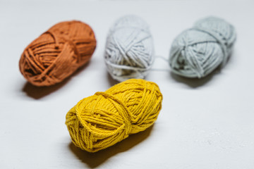 Fototapeta na wymiar Colorful small wool yarns on white background isolated.