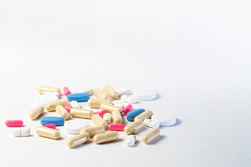 Medicine, virus treatment. Coronavirus vaccine, Covid19. Capsules and pills pink and blue, white background Pandemic medicine.