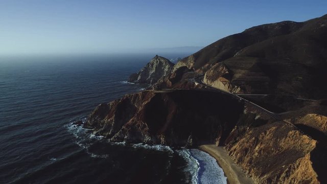 Cinematic aerial shot of the California coastline showing the Devils Slide area on Highway One. UHD, 4K.
