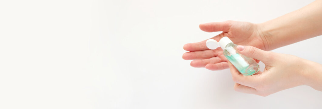 Bottle With Antibacterial Antiseptic Gel In Hand On White