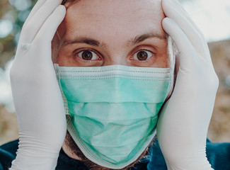 Man wearing face mask and gloves to prevent contamination, shocked