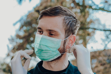 Man wearing face mask and gloves to prevent contamination