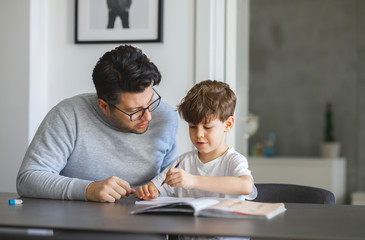 Farther Helping Son to finish his Homework