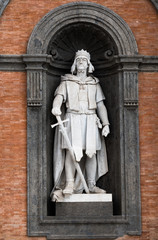 Fototapeta na wymiar Statue of Roger II at the entrance of Palazzo Reale in Piazza del Plebbiscito in Naples,