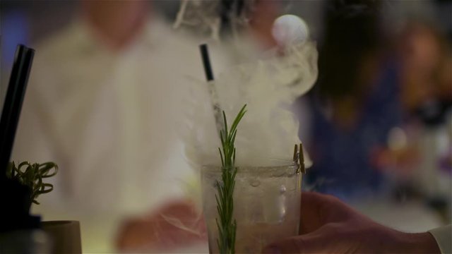 bartender preparing dry ice drink at club