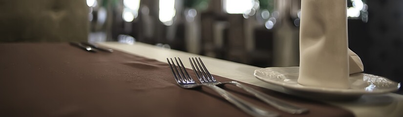 fork and knife serving in the interior of the restaurant / table in a cafe, food industry catering,...