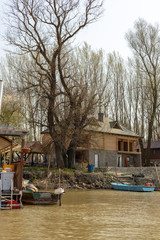 Obraz premium Wooden Weekend House On The River Bank On A Sunny Day