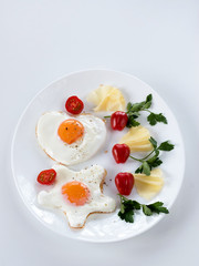 Fried eggs for breakfast with tomatoes, herbs and cheese. Proper nutrition concept.