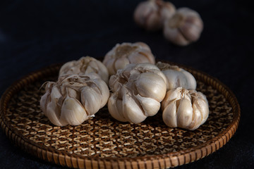 Garlic is placed on the white table in the kitchen, preparing for cooking, Concept: The ingredients of vegetarian ingredients are very much about nature for good health, background  aromatic herbs 