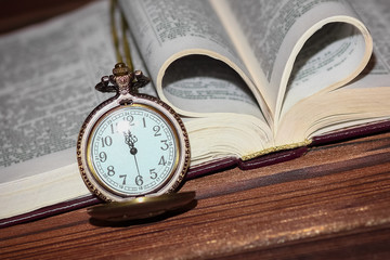 a pocket watch with book background