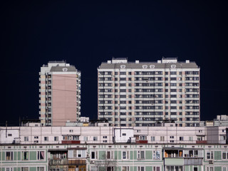 Fototapeta na wymiar Clear dark sky over apartment buildings of the urban district. Panorama of the cityscape before storm. Moscow city, Russia.
