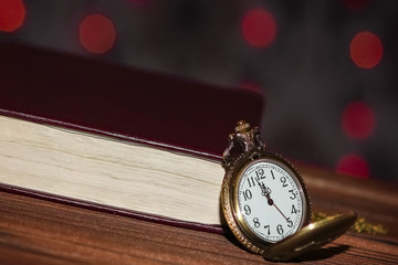 a pocket watch with book background