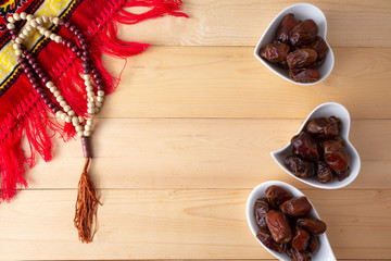food Ramadan Sweets dried fruits and nuts Tea with a rosary and the on the table wood, Concept: month fasting culture Muslim and prayer for god, Ramadhan food symbolic eastern Arabian