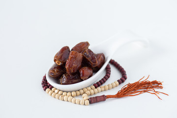 food Ramadan  date Sweets mixed of dried fruits and nuts Glass Tea with a rosary and the Quran, Concept: month fasting culture Muslim and prayer for god, Ramadhan food symbolic eastern Arabian