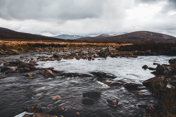 Scottish highlands, dramatic sky and river
