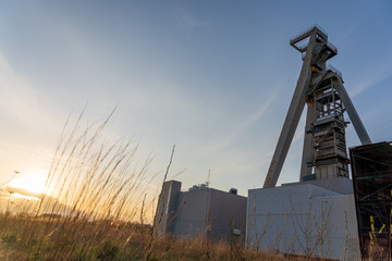 Fototapeta na wymiar sunset over coal mine called zeche huge in gelsenkirchen germany