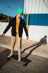 Portrait of a guy with a skateboard. Modern skater concept