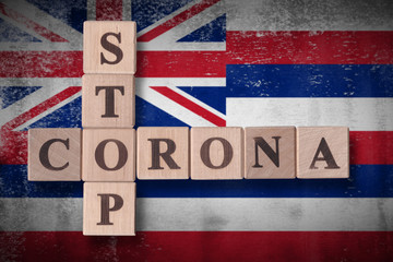 Flag of the state of Hawaii with wooden cubes spelling STOP CORONA on it. 2019 - 2020 Novel Coronavirus (2019-nCoV) concept art, for an outbreak occurs in Hawaii, US.