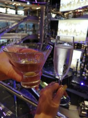 Two bartender pouring cocktail into bar