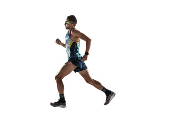 Fototapeta na wymiar Triathlon male athlete running isolated on white studio background. Caucasian fit jogger, triathlete training wearing sports equipment. Concept of healthy lifestyle, sport, action, motion. Side view.