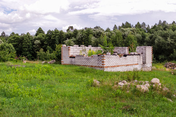 abandoned unfinished white brick house.