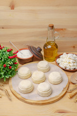Cheesecakes on a wooden board with cottage cheese