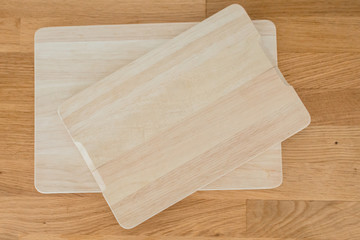 Kitchen wooden boards for cutting rye, vegetables, fruits, meat on the table. Wooden background