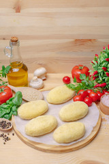 Pies on a wooden board with vegetables