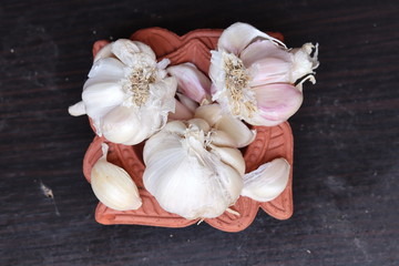 One whole aromatic white garlic isolated on black background
