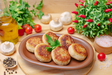 Pies on a wooden board with vegetables