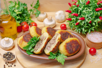 Pies on a wooden board with meat