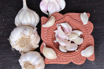 One whole aromatic white garlic isolated on black background