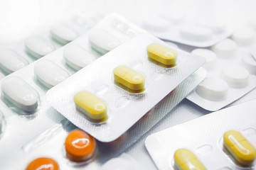The concept of pills for treatment. Multi-colored pills in blisters on a white background isolate. Copy space. 