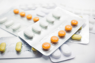The concept of pills for treatment. Multi-colored pills in blisters on a white background isolate. Copy space. Place for text.