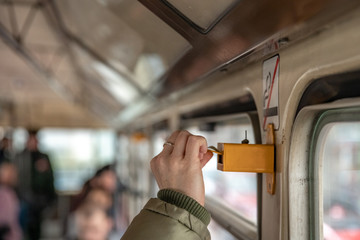 A woman denotes a public transport ticket by punching