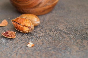 Natural pecan nuts on dark background.