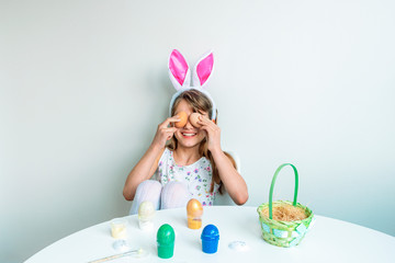 Obraz na płótnie Canvas Cute little girl playing with Easter eggs