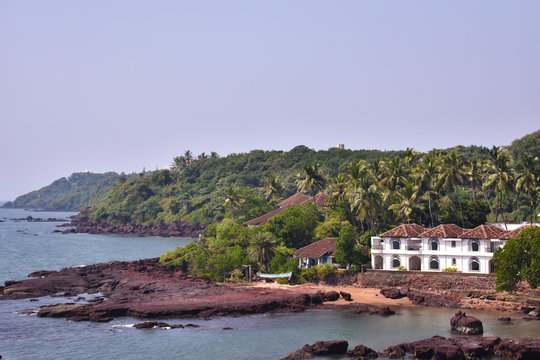 image of a shore with a house beside it in Goa