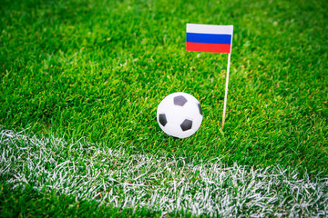 Russia national Flag and football ball on green grass. Fans, support photo, edit space