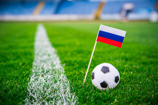 Russia national Flag and football ball on green grass. Fans, support photo, edit space