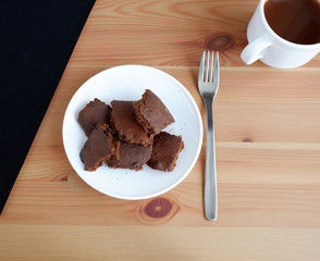 Brownie cake with a Cup of cocoa, on a wooden background