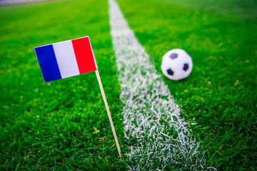 Obraz premium France national Flag and football ball on green grass. Fans, support photo, edit space