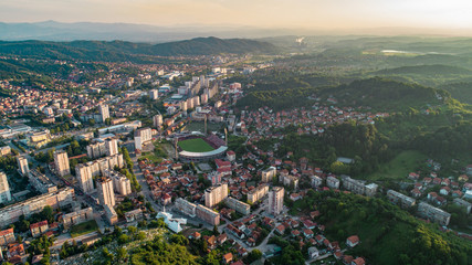 Aerial view of downtown Tuzla at sunset, Bosnia. City photographed by drone, traffic and objects , landscape.city photographed from air by drone.Old balkan buildings and communism type of architecture