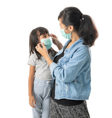 mother and daughter wearing face masks. corona virus attack