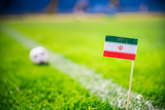 IR IRAN national Flag and football ball on green grass. Fans, support photo, edit space