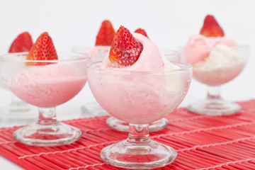 cups for ice cream with strawberry ice cream and strawberries