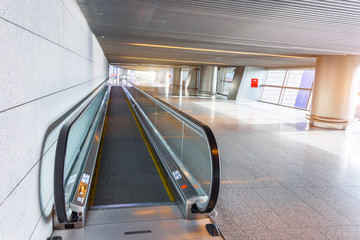 An empty travelator in the terminal of the airport for an accelerated transfer of passengers,...