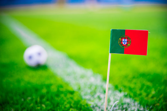 Portugal national Flag and football ball on green grass. Fans, support photo, edit space